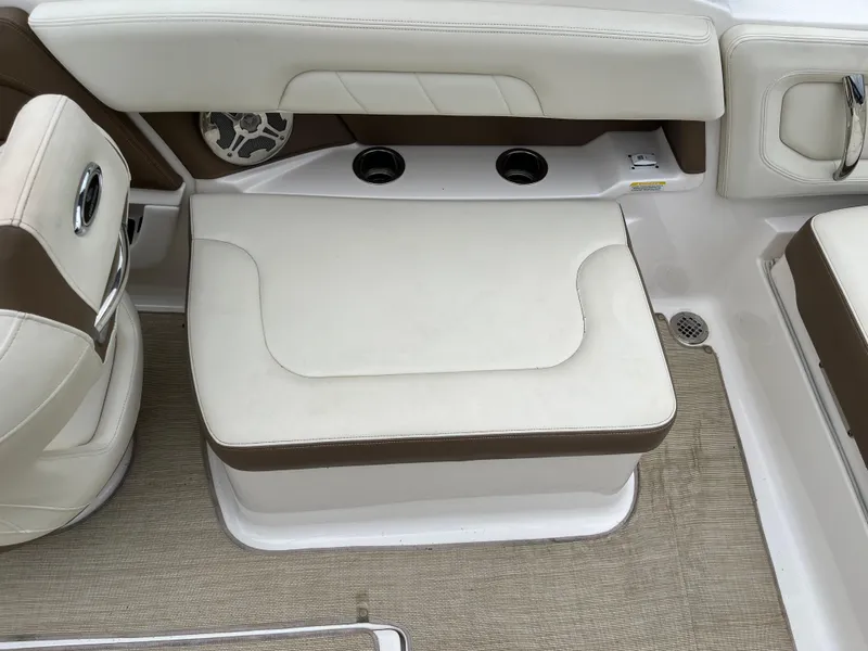 Slide: The Image of 2014 Chaparral 257 SSX boat interior with beige seating and cup holders. - 13