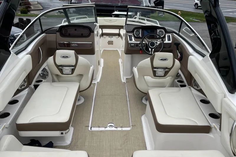 Slide: The Image of 2014 Chaparral 257 SSX boat interior with beige seating and modern dashboard. - 16