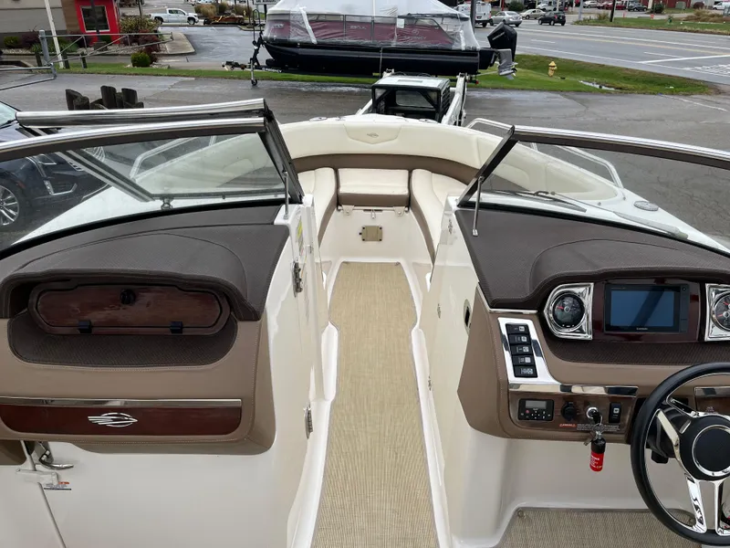 Slide: The Image of 2014 Chaparral 257 SSX boat interior with dashboard and seating area. - 3