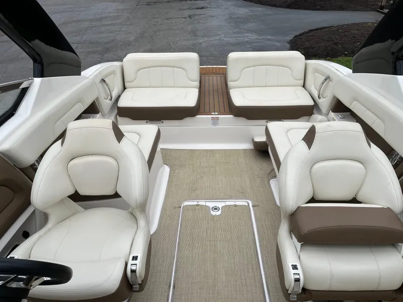 Slide: The Image of 2014 Chaparral 257 SSX boat interior with white leather seating and beige flooring. - 6