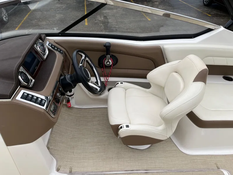 Slide: The Image of 2014 Chaparral 257 SSX boat interior with steering wheel and captain's chair. - 7