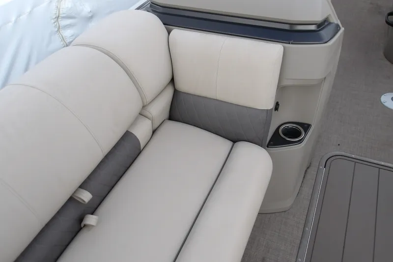 Slide: The Image of 2025 Sun Tracker Fishin' Barge 22 XP3 interior seating with cup holder, beige upholstery. - 16