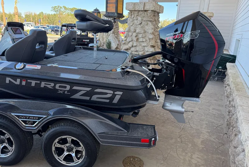 Slide: The Image of 2025 Nitro Z21 XL boat with powerful outboard motor on a trailer. - 2