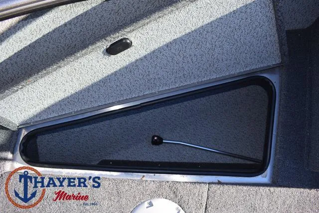 Slide: The Image of 2023 Lund 1875 Fisherman Sport boat storage compartment, Thayer's Marine logo visible. - 13