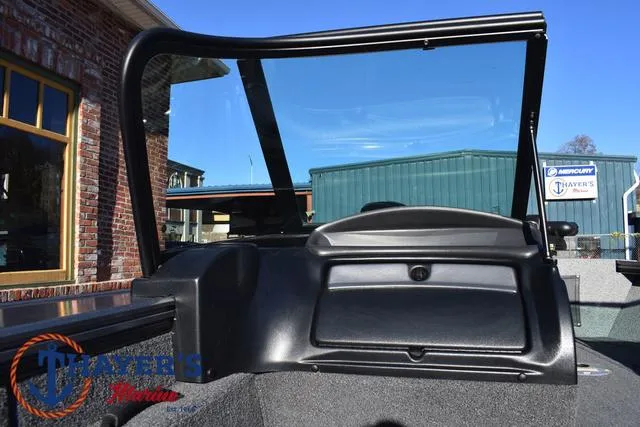 Slide: The Image of 2023 Lund 1875 Fisherman Sport boat interior with windshield and dashboard. - 17