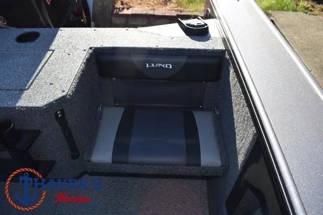 Slide: The Image of 2023 Lund 1875 Fisherman Sport boat seat with logo, gray and black upholstery. - 24