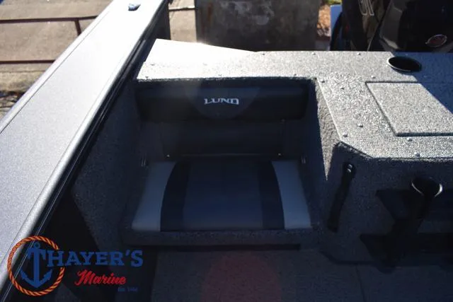 Slide: The Image of 2023 Lund 1875 Fisherman Sport boat interior with seating, Thayer's Marine logo visible. - 25