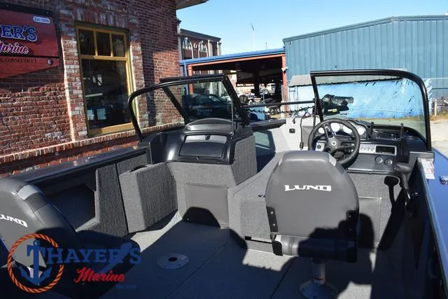 Slide: The Image of 2023 Lund 1875 Fisherman Sport boat interior with steering wheel and seating. - 26