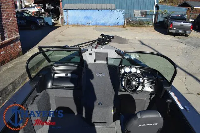 Slide: The Image of 2023 Lund 1875 Fisherman Sport boat interior with steering wheel and dashboard. - 27