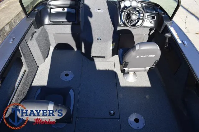 Slide: The Image of 2023 Lund 1875 Fisherman Sport boat interior with seating and steering console. - 28