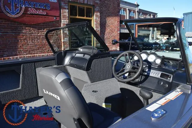 Slide: The Image of 2023 Lund 1875 Fisherman Sport boat interior with steering wheel and dashboard. - 31