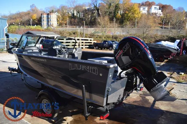 Slide: The Image of 2023 Lund 1875 Fisherman Sport boat with powerful outboard motor in a marina setting. - 9