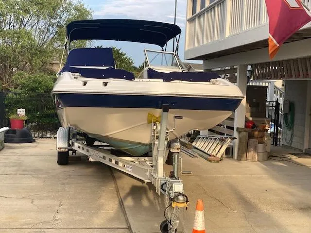 Slide: The Image of 2006 Hurricane SunDeck 237 OB boat on trailer in driveway. - 6