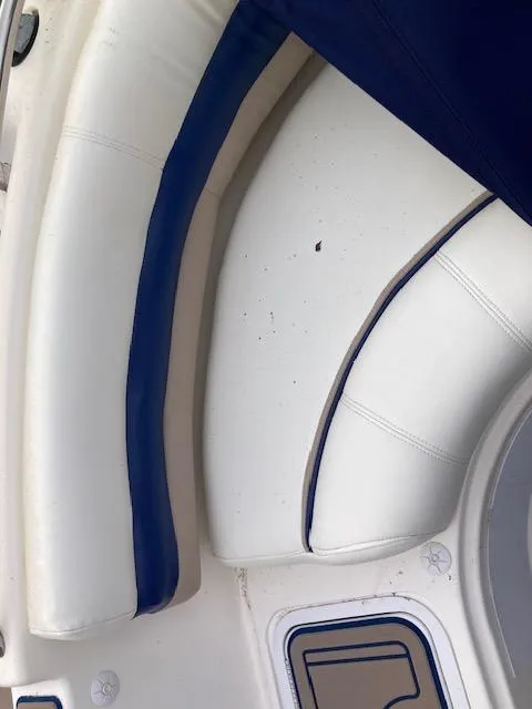 Slide: The Image of 2006 Hurricane SunDeck 237 OB boat interior with white and blue seating. - 9