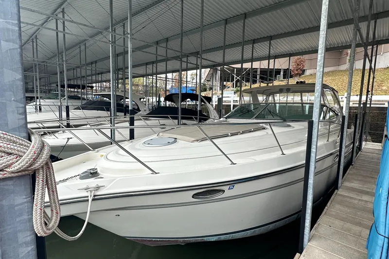 Slide: The Image of 1998 Maxum 3700 SCR yacht docked in a covered marina. - 12