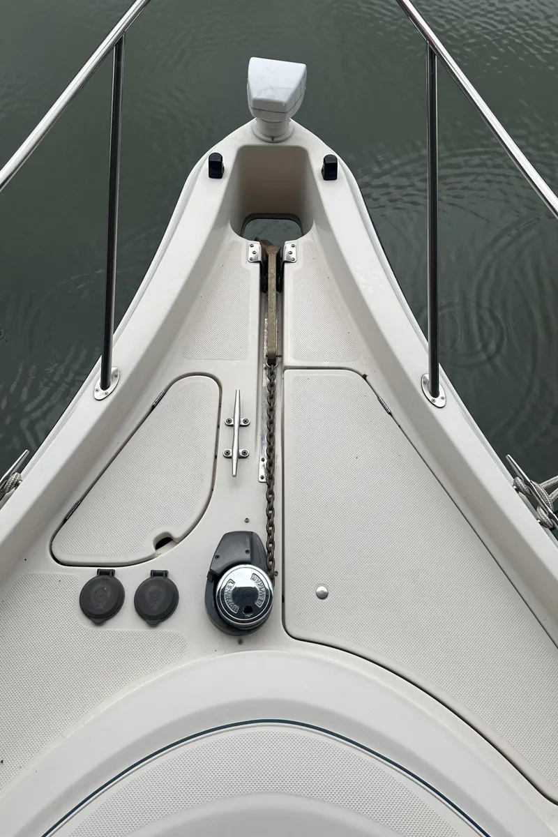 Slide: The Image of Bow of 1998 Maxum 3700 SCR boat with anchor chain and deck details. - 15