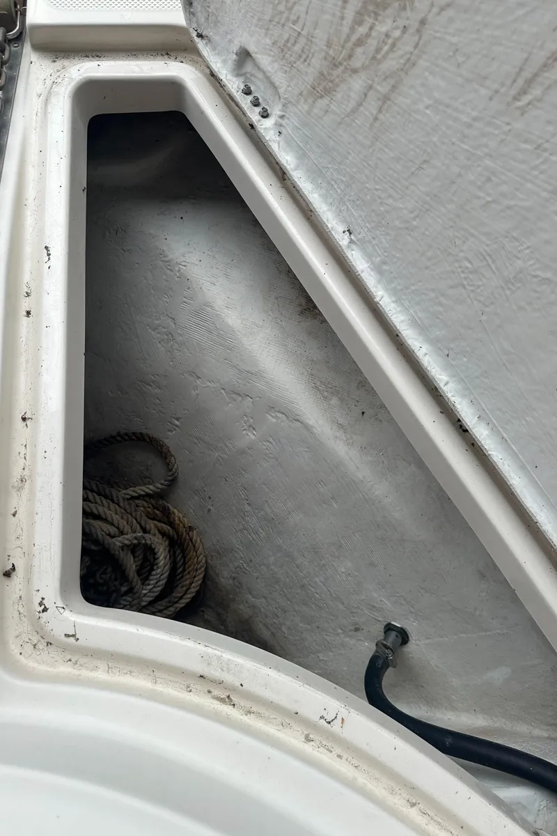 Slide: The Image of Storage compartment of 1998 Maxum 3700 SCR boat with coiled rope. - 16