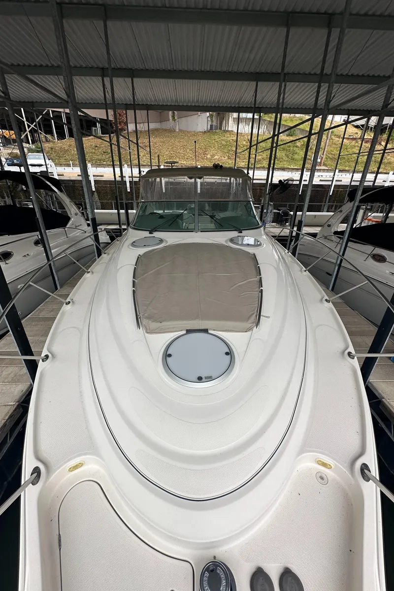 Slide: The Image of 1998 Maxum 3700 SCR boat docked under a covered marina. - 17