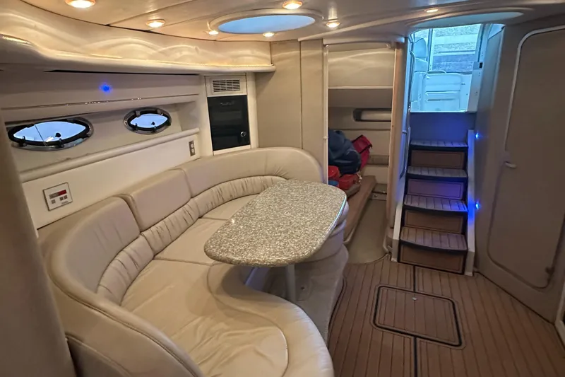 Slide: The Image of Luxurious interior of 1998 Maxum 3700 SCR yacht with plush seating and elegant table. - 2