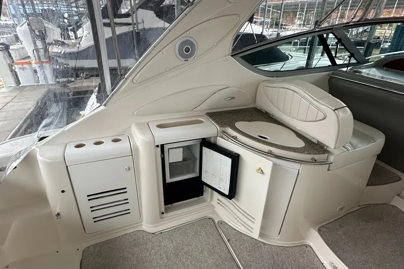 Slide: The Image of 1998 Maxum 3700 SCR yacht interior with mini fridge and seating area. - 20