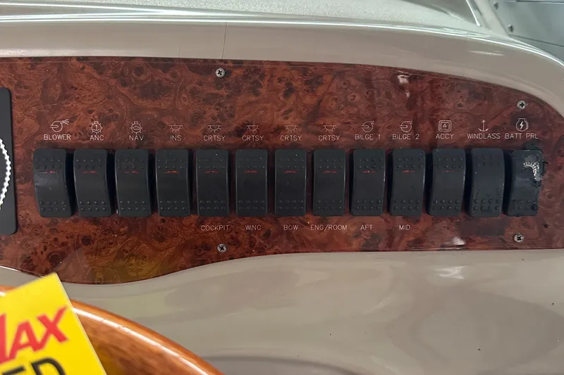 Slide: The Image of Control panel of a 1998 Maxum 3700 SCR boat with labeled switches. - 29