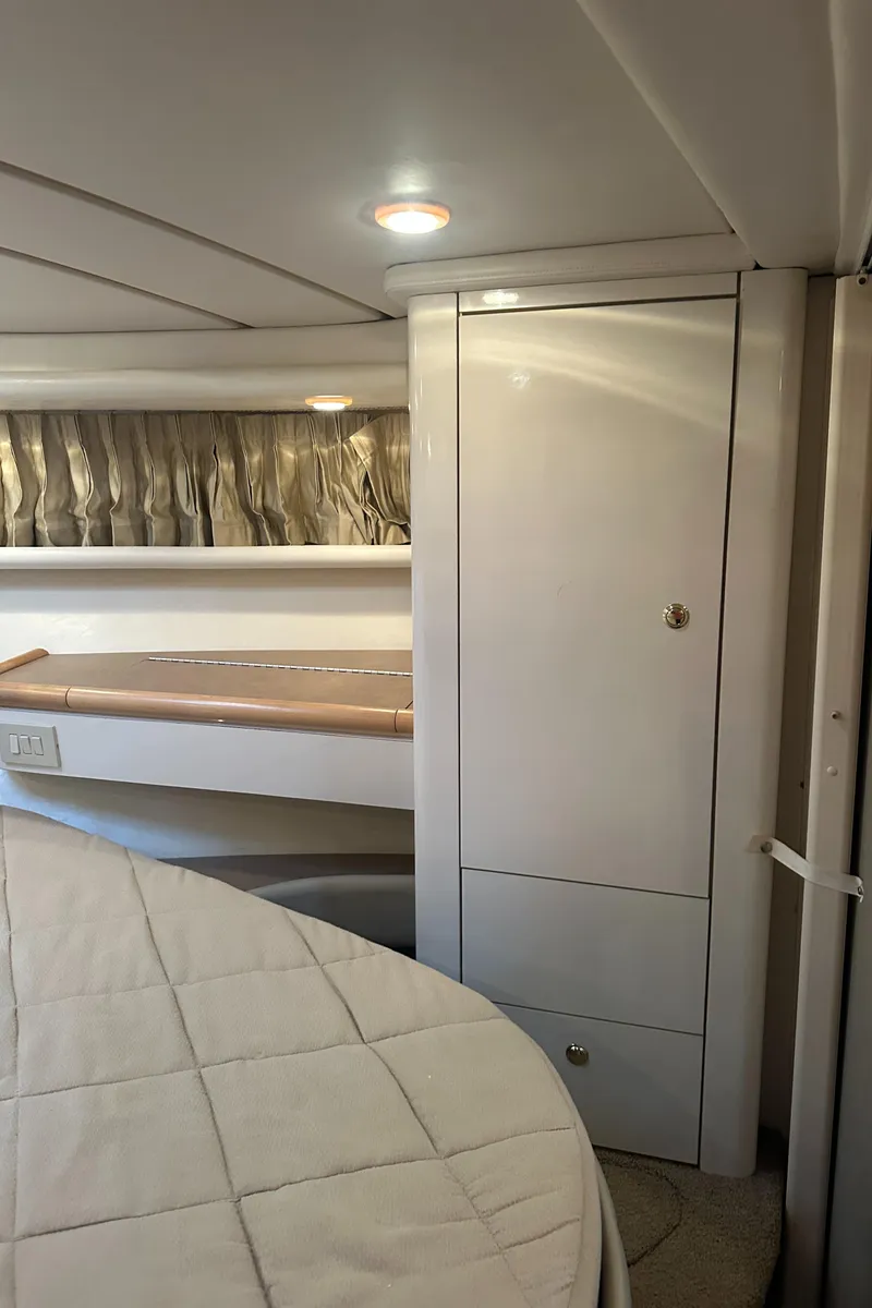 Slide: The Image of Interior of 1998 Maxum 3700 SCR yacht, featuring sleek cabinetry and cozy sleeping area. - 31