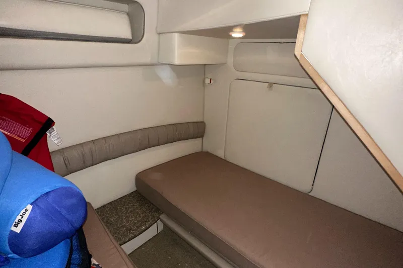 Slide: The Image of 1998 Maxum 3700 SCR cabin interior with seating and life jacket. - 33