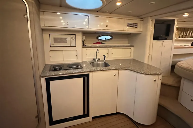 Slide: The Image of 1998 Maxum 3700 SCR yacht interior kitchen with sink, stove, and microwave. - 39