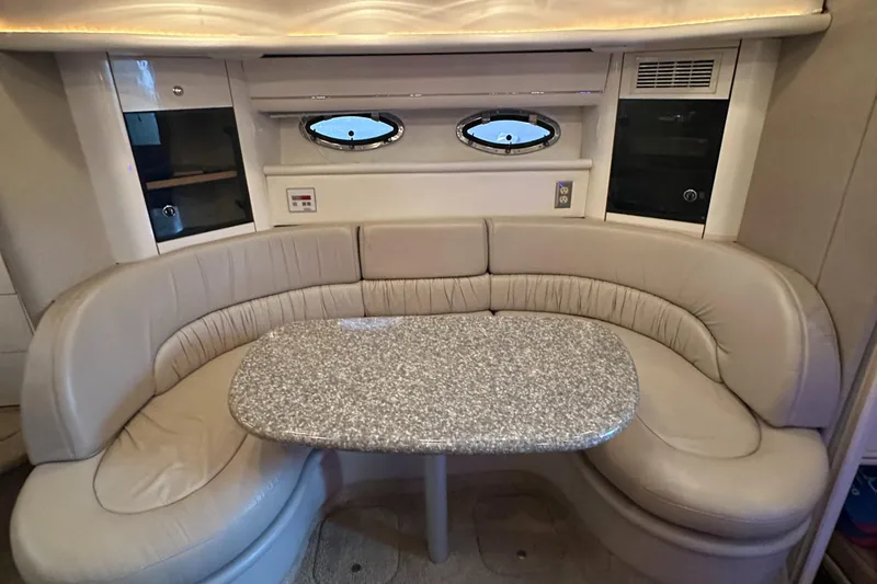 Slide: The Image of 1998 Maxum 3700 SCR yacht interior with curved seating and oval windows. - 4