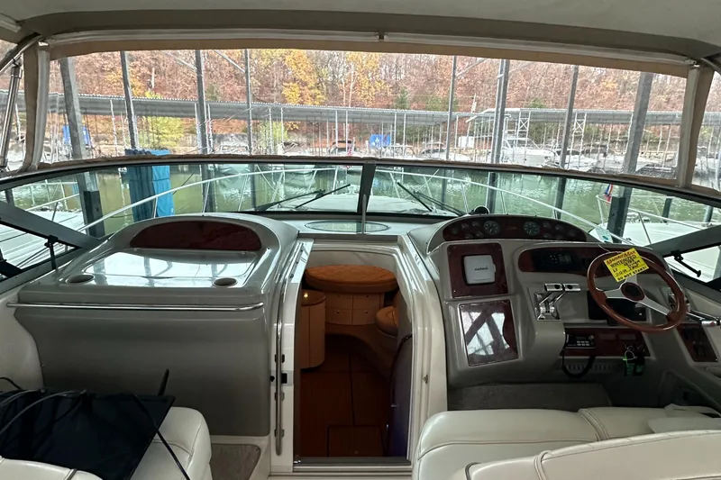 Slide: The Image of Interior view of 1998 Maxum 3700 SCR yacht cockpit with steering wheel and controls. - 41