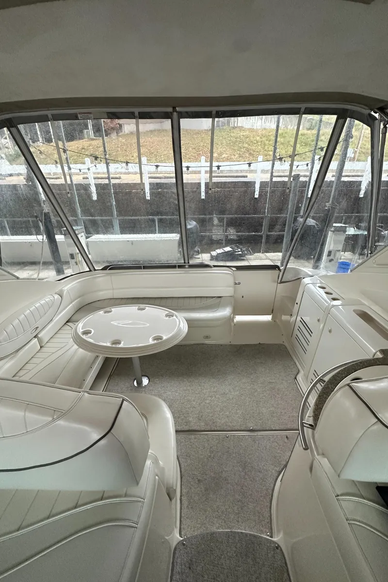Slide: The Image of 1998 Maxum 3700 SCR yacht interior with seating and table, featuring large windows. - 44