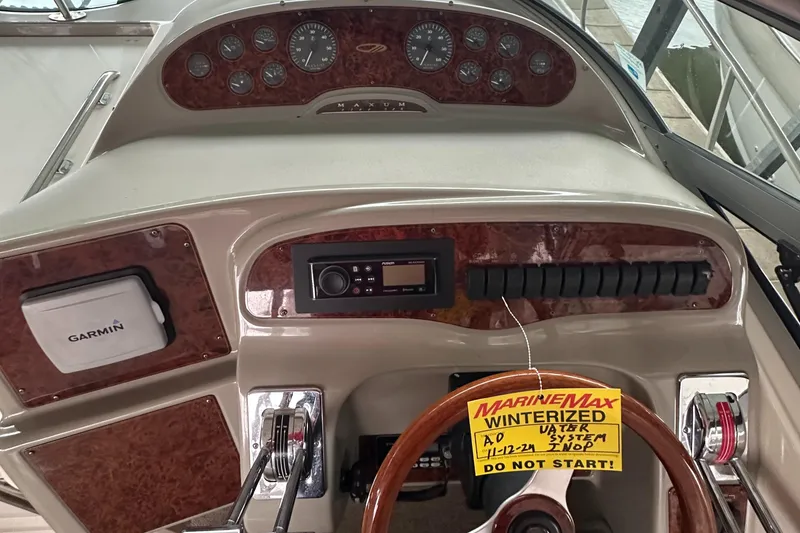 Slide: The Image of 1998 Maxum 3700 SCR boat dashboard with Garmin device and winterization notice. - 8