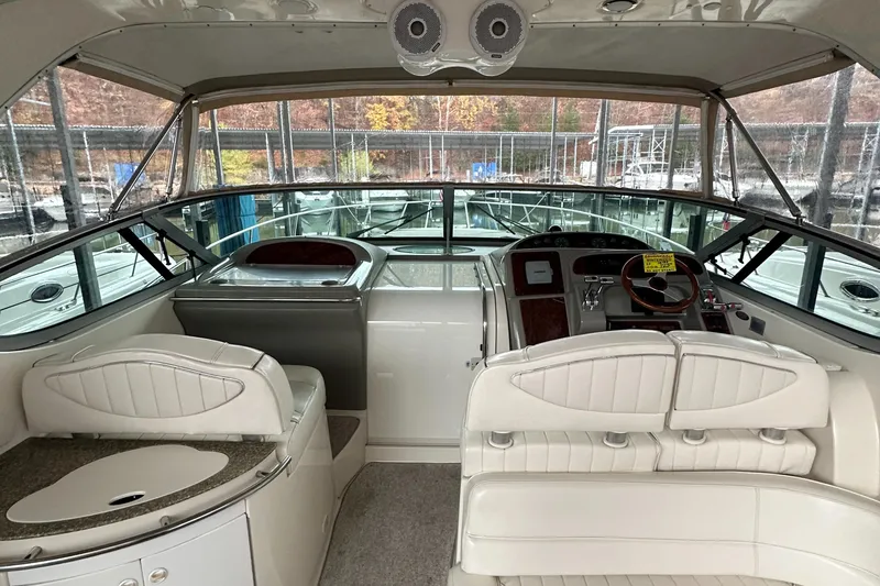 Slide: The Image of 1998 Maxum 3700 SCR yacht interior with white seating and helm station. - 9