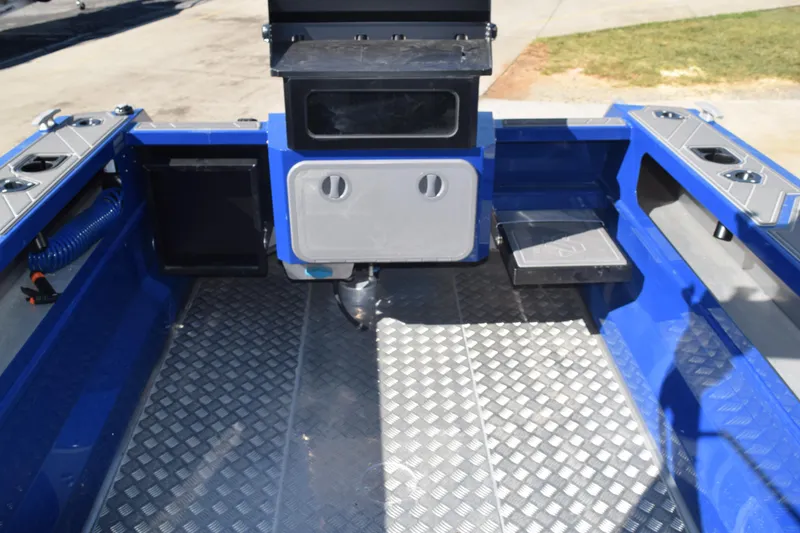 Slide: The Image of 2024 Stabicraft 1850 Fisher Sportfish interior with blue accents and diamond plate flooring. - 10