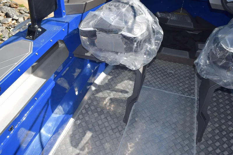 Slide: The Image of 2024 Stabicraft 1850 Fisher Sportfish interior with blue accents and protective seat covers. - 16