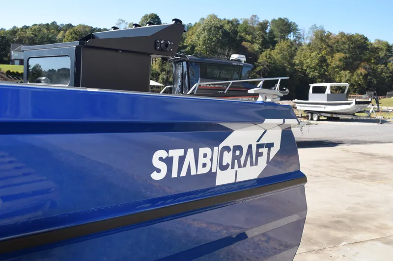 Slide: The Image of 2024 Stabicraft 1850 Fisher Sportfish boat in blue, parked outdoors. - 19