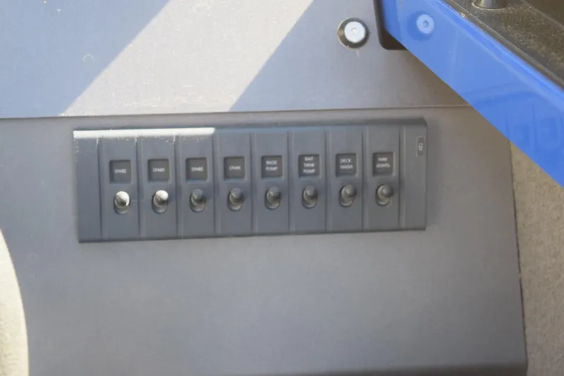 Slide: The Image of Control panel of 2024 Stabicraft 1850 Fisher Sportfish boat with labeled switches. - 7