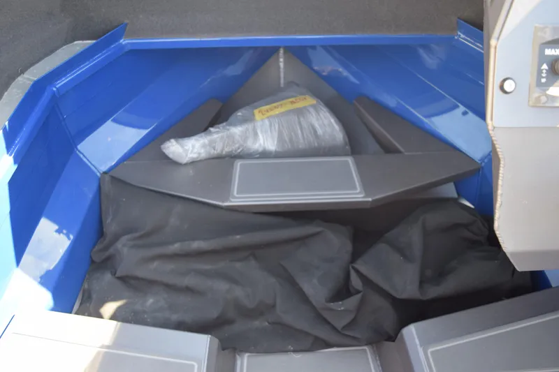 Slide: The Image of 2024 Stabicraft 1850 Fisher Sportfish interior storage area with blue and gray accents. - 9