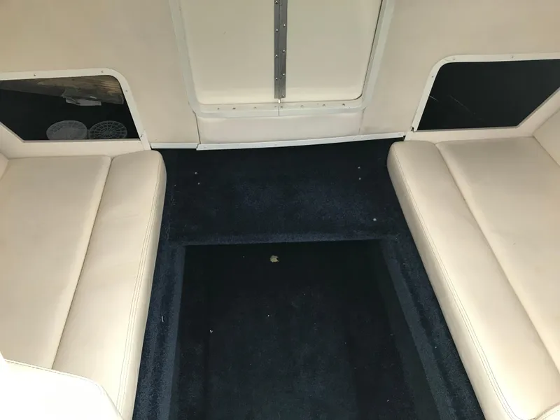 Slide: The Image of 2007 Donzi 28 ZX Open interior with beige seating and dark carpet. - 12