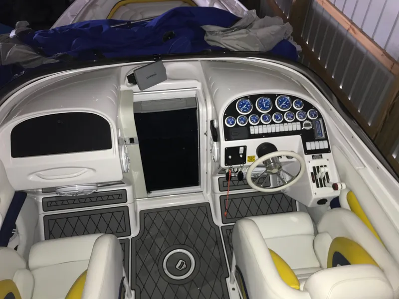 Slide: The Image of 2007 Donzi 28 ZX Open boat cockpit with white and yellow seating, detailed dashboard, and steering wheel. - 19