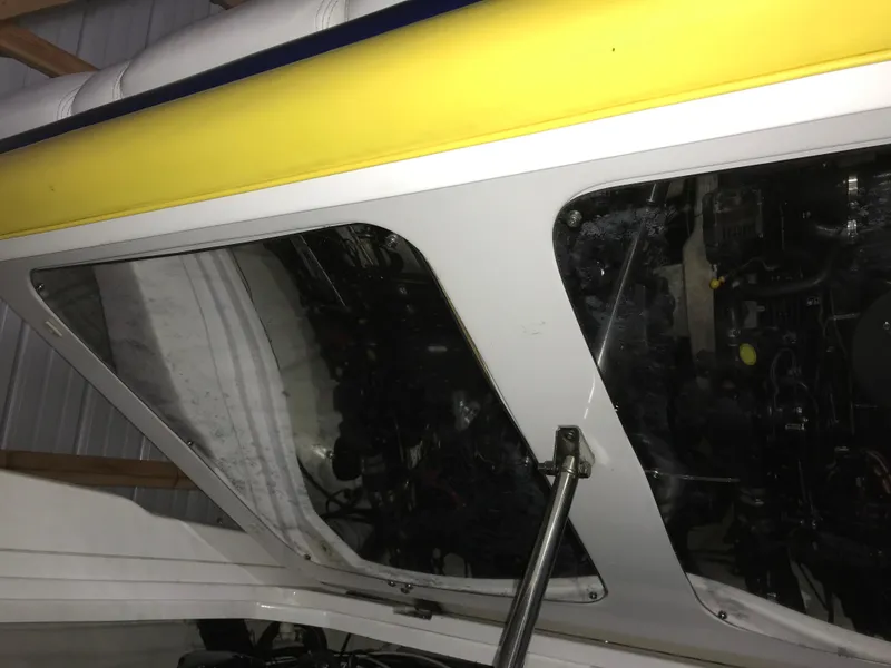 Slide: The Image of 2007 Donzi 28 ZX Open boat engine compartment with yellow and white exterior. - 28