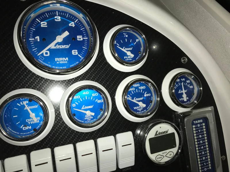 Slide: The Image of Dashboard of a 2007 Donzi 28 ZX Open boat with blue Livorsi gauges. - 39