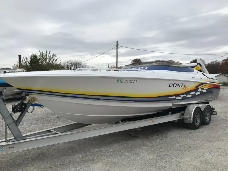 Slide: The Image of 2007 Donzi 28 ZX Open boat on trailer, white with yellow and blue accents. - 4