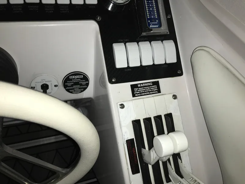 Slide: The Image of Control panel of a 2007 Donzi 28 ZX Open boat, featuring switches and throttle levers. - 42