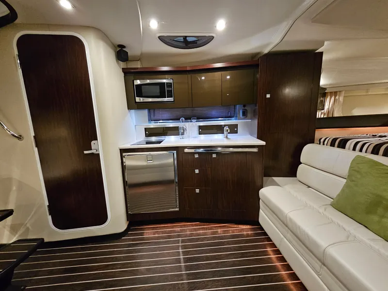 Slide: The Image of Interior of 2016 Monterey 355 Sport Yacht with modern helm and seating, docked at marina. - 11