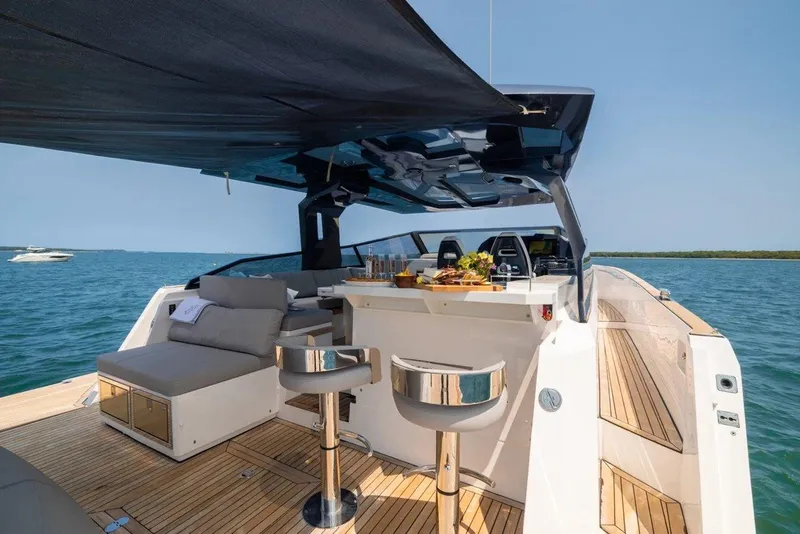 Slide: The Image of Luxurious 2023 OKEAN 57 yacht with sleek deck and modern seating on open water. - 12