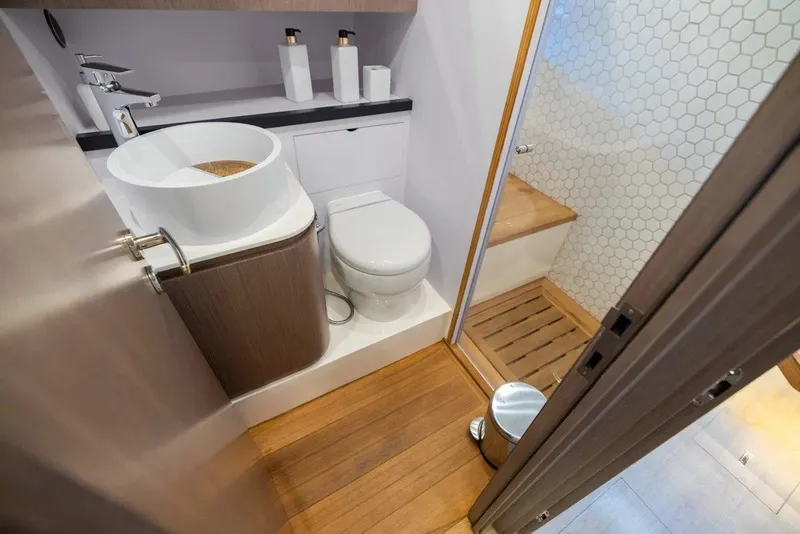 Slide: The Image of Modern bathroom on 2023 OKEAN 57 yacht with wood flooring and sleek fixtures. - 9
