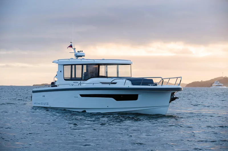 Slide: The Image of Nimbus C11 2025 boat cruising on open water at sunset. - 13