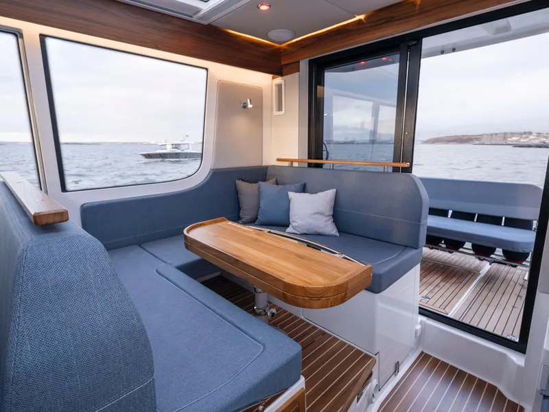 Slide: The Image of Luxurious interior of 2025 Nimbus C11 yacht with ocean view and modern seating. - 25