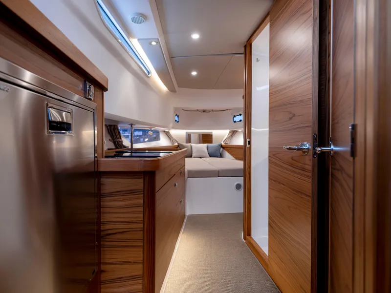 Slide: The Image of Luxurious interior of 2025 Nimbus C11 yacht with modern wood finishes and cozy seating area. - 31